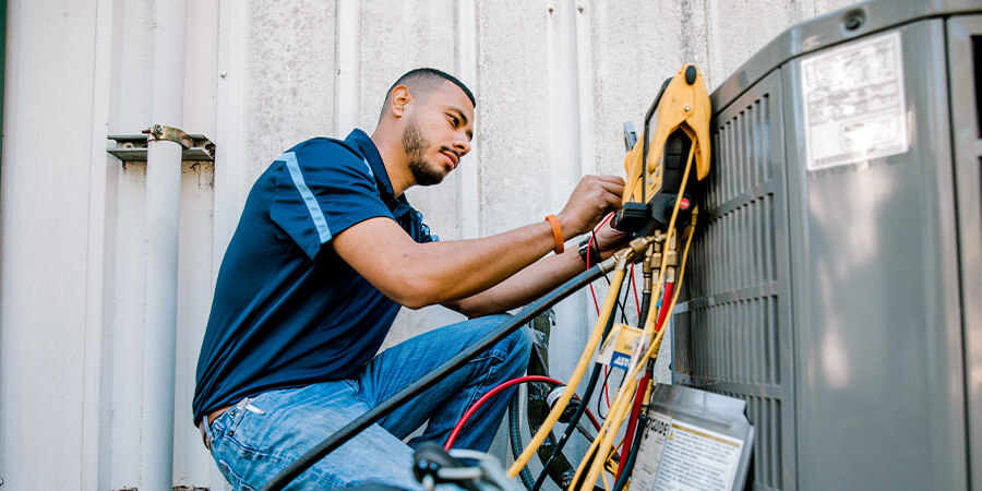 Service technician working on air conditioner