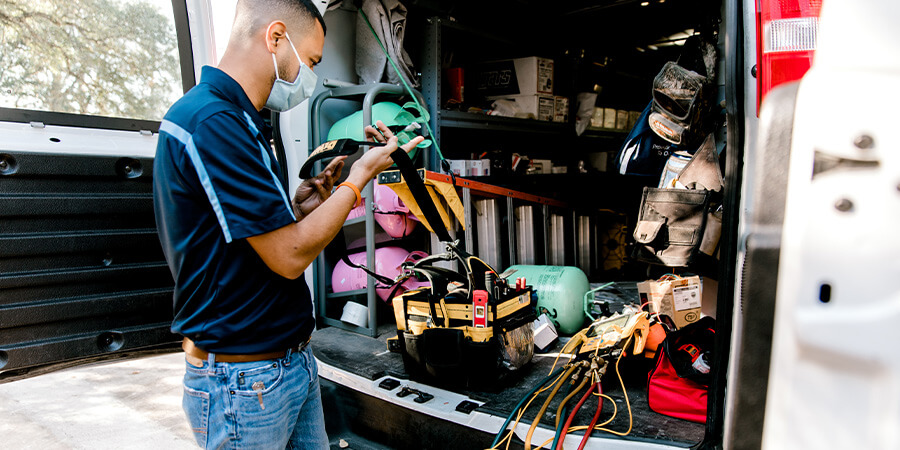 Service technician repairing furnace