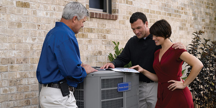 Homeowners and service technician talking